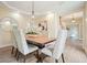 Elegant dining room with a wood table, modern chandelier, tray ceiling, and hardwood floors at 465 Woodbrook Ways, Lawrenceville, GA 30043