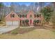 Charming brick two-story house with a two-car garage, black shutters, and a manicured front lawn at 465 Woodbrook Ways, Lawrenceville, GA 30043