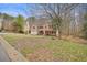 Traditional brick home with a well-manicured lawn and mature trees, offering charm and curb appeal at 465 Woodbrook Ways, Lawrenceville, GA 30043