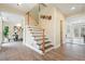 Welcoming foyer with hardwood floors, a staircase with white risers, and views of adjacent rooms at 465 Woodbrook Ways, Lawrenceville, GA 30043