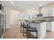 Open kitchen with a kitchen island, modern appliances, and stylish gray seating at 465 Woodbrook Ways, Lawrenceville, GA 30043