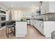 Bright kitchen with white cabinets, stainless steel appliances, and an island with seating at 465 Woodbrook Ways, Lawrenceville, GA 30043