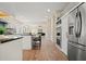 Open-concept kitchen with island and stainless steel appliances visible from living area at 465 Woodbrook Ways, Lawrenceville, GA 30043