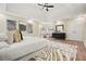 Spacious main bedroom featuring tray ceilings, hardwood floors, and zebra print rug at 465 Woodbrook Ways, Lawrenceville, GA 30043