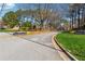 Community entrance with colorful flowers and mature trees, showing well maintained landscaping at 465 Woodbrook Ways, Lawrenceville, GA 30043