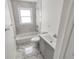 Renovated bathroom featuring marble tile, a new vanity, and a shower-tub combination at 81 Burbank Nw Dr, Atlanta, GA 30314