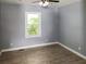 Serene bedroom featuring wood-look floors, natural light, and a ceiling fan at 81 Burbank Nw Dr, Atlanta, GA 30314