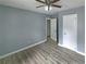 Light-filled bedroom features a ceiling fan, new paint, wood-look flooring, and white trim at 81 Burbank Nw Dr, Atlanta, GA 30314