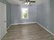 Freshly painted bedroom with modern ceiling fan, durable wood floors, and bright window views at 81 Burbank Nw Dr, Atlanta, GA 30314