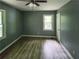 Cozy bedroom with wood-look flooring, a ceiling fan, and a window for natural light at 81 Burbank Nw Dr, Atlanta, GA 30314