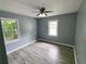 Cozy bedroom with wood-look floors, new paint, two windows, and ceiling fan at 81 Burbank Nw Dr, Atlanta, GA 30314