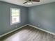 Inviting bedroom with wood-style floors, a window, and neutral decor at 81 Burbank Nw Dr, Atlanta, GA 30314