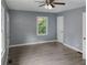 Bright bedroom with wood-look flooring, a ceiling fan, and a window with a view at 81 Burbank Nw Dr, Atlanta, GA 30314