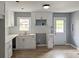 Modern kitchen with white cabinets, ample counter space, and a view of the outdoors at 81 Burbank Nw Dr, Atlanta, GA 30314