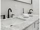 Stylish bathroom with a marble countertop and double sinks, ideal for modern living at 912 Ira Sw St, Atlanta, GA 30310