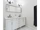 Modern bathroom with marble countertops, dual sinks, matte black fixtures, and sleek white cabinets at 912 Ira Sw St, Atlanta, GA 30310