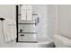 This bathroom features a tub with glass shower door and modern fixtures at 912 Ira Sw St, Atlanta, GA 30310