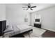 Modern bedroom with a sleek ceiling fan, large window, and sophisticated furniture, creating a relaxing retreat at 912 Ira Sw St, Atlanta, GA 30310