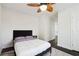 Relaxing bedroom with a plush bed, modern ceiling fan, and minimalist decor, offering a peaceful ambiance at 912 Ira Sw St, Atlanta, GA 30310