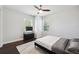 Bright bedroom featuring hardwood floors, a ceiling fan, and natural light from two windows at 912 Ira Sw St, Atlanta, GA 30310