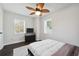 Comfortable bedroom with a ceiling fan, large window, and sleek furniture, creating a serene retreat at 912 Ira Sw St, Atlanta, GA 30310