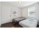 Cozy bedroom with two twin beds, bright natural light, and neutral decor, perfect for a shared space at 912 Ira Sw St, Atlanta, GA 30310