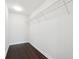 Empty closet with dark wood floors and white walls, featuring a wire shelf and a clean, organized space at 912 Ira Sw St, Atlanta, GA 30310