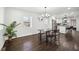 Dining area with hardwood floors, modern table with benches, lots of natural light, and open to the kitchen at 912 Ira Sw St, Atlanta, GA 30310
