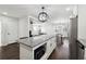 Modern kitchen with granite countertops, stainless steel appliances, and an island with microwave at 912 Ira Sw St, Atlanta, GA 30310