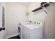 Functional laundry area includes a washer, dryer, and overhead shelving for storage at 912 Ira Sw St, Atlanta, GA 30310