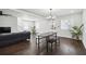 Open concept living area with hardwood floors, a dining area, and a dark-colored couch and stairs at 912 Ira Sw St, Atlanta, GA 30310