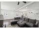 Bright open-concept living room with hardwood floors, grey sectional couch, and decorative world map on wall at 912 Ira Sw St, Atlanta, GA 30310