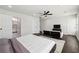 Bright main bedroom featuring a ceiling fan, hardwood flooring, and ensuite bathroom at 912 Ira Sw St, Atlanta, GA 30310