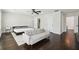 Large primary bedroom boasts ample space, hardwood flooring, and a ceiling fan at 912 Ira Sw St, Atlanta, GA 30310
