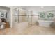 Bright bathroom features a glass shower, freestanding tub, and natural light at 1195 Cameron Ct, Atlanta, GA 30306