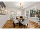 Elegant dining room with wood floors, wainscoting, a modern chandelier, and large windows at 1195 Cameron Ct, Atlanta, GA 30306