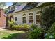 Charming two-story home featuring a stone-arched entry, and mature trees at 1195 Cameron Ct, Atlanta, GA 30306