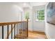 Upstairs hallway with hardwood floors and natural light from two windows at 1195 Cameron Ct, Atlanta, GA 30306