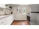 Cozy kitchen with stainless steel appliances, white cabinets, and a bright window for natural light at 1195 Cameron Ct, Atlanta, GA 30306