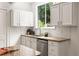 Charming kitchen featuring granite countertops, white cabinets, stainless steel appliances, and a view to the outside at 1195 Cameron Ct, Atlanta, GA 30306