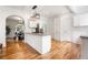 Open-concept kitchen showcasing white cabinetry, granite countertops, hardwood floors, and a view into the dining area at 1195 Cameron Ct, Atlanta, GA 30306