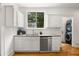 Bright kitchen featuring white cabinets, stainless steel appliances, and natural light, plus a view to a laundry area at 1195 Cameron Ct, Atlanta, GA 30306