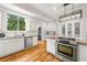 Bright kitchen featuring white cabinets, granite countertops, stainless steel appliances, and hardwood floors at 1195 Cameron Ct, Atlanta, GA 30306
