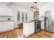 Bright kitchen features white cabinets, granite countertops, stainless steel appliances and wood floors at 1195 Cameron Ct, Atlanta, GA 30306