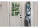 Bright laundry room features a stacked washer and dryer and access to the outdoors at 1195 Cameron Ct, Atlanta, GA 30306