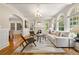 Bright living room with large arched windows, fireplace, hardwood floors, and stylish modern furniture at 1195 Cameron Ct, Atlanta, GA 30306