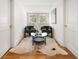 Cozy sitting area with hardwood floors, seating, and a round glass coffee table at 1195 Cameron Ct, Atlanta, GA 30306