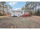 Spacious backyard with white home exterior, wooden deck and expansive lawn space at 2248 Bethel Rd, Conyers, GA 30012