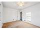 Bedroom with ceiling fan, tan carpet, and closet with door ajar at 2248 Bethel Rd, Conyers, GA 30012