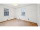 A bright bedroom has a ceiling fan, windows and tan carpet at 2248 Bethel Rd, Conyers, GA 30012